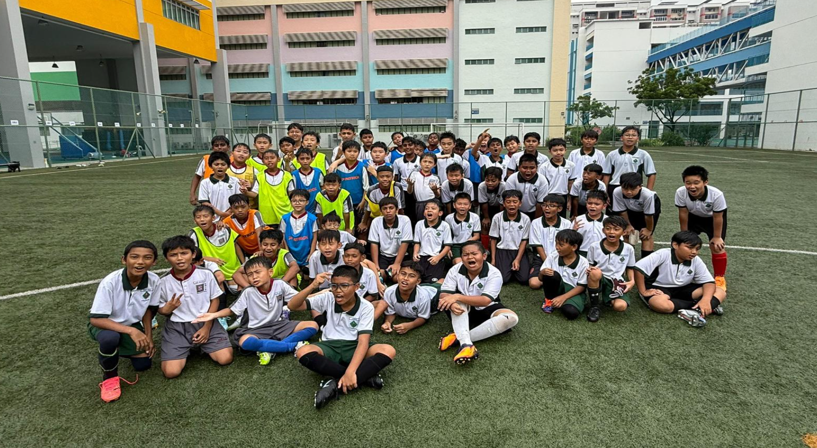 The soccer boys from the junior and senior division posing for a group photo.